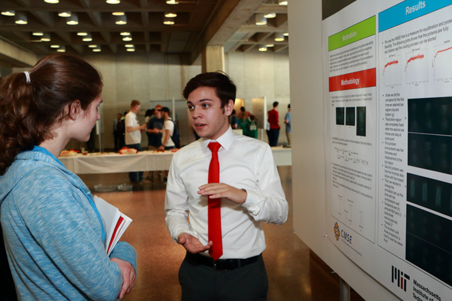 Summer Scholar Jahzeel Rosado Vega, right, explains his poster on wave propagation in spider silk protein fibers to materials science and engineering graduate student Sarah Goodman. Rosado’s studies, under professor of civil and environmental engineering Markus Buehler, simulated the fiber’s molecular structure.