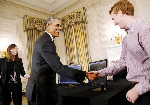 President Barack Obama greets MIT Professor Dina Katabi and graduate student Zachary Kabelac at the White House. (Not pictured: Fadel Adib.)