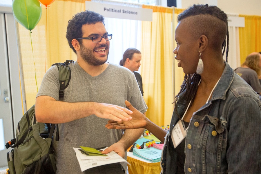 Professor Charlotte Brathwaite discusses theater classes with student at the TOUR de SHASS.