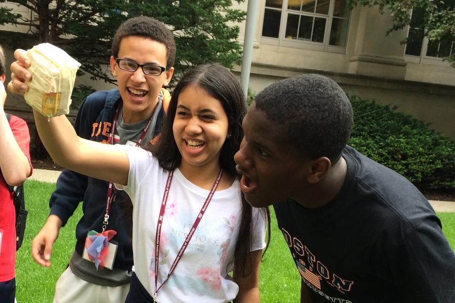 Jonathan Castillo of Lawrence, Daniela Reyes of Lawrence, and Kashetu Oseni of Boston check to see if their egg survived the three-story drop.