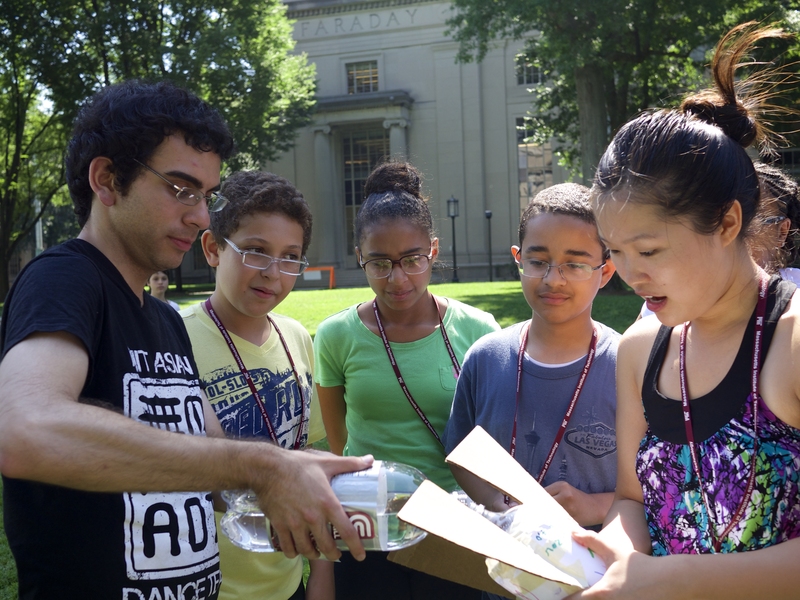 Instructor Jonathan Corzo, Mehdi Kayi of Boston, Leah Delacruz and Giancarlos Jamie-Guzman of Lawrence, and instructor Julia Sun prepare to launch a bottle rocket.