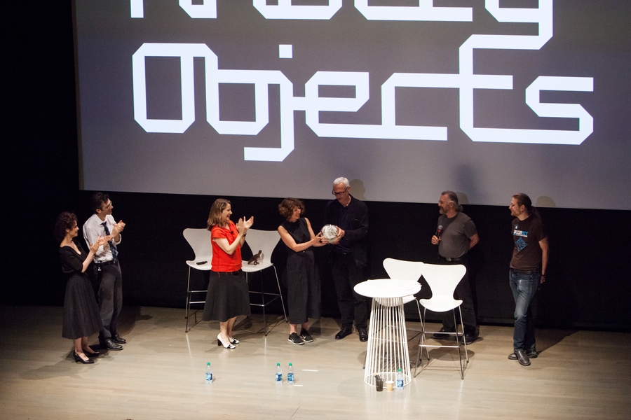 Fiona Raby and Anthony Dunne (center, in black) receive the Media Lab Award at the Knotty Objects summit. The others on stage are (from left) Neri Oxman, Kevin Slavin, Paola Antonelli, Martin Demaine, and Eric Demaine. 