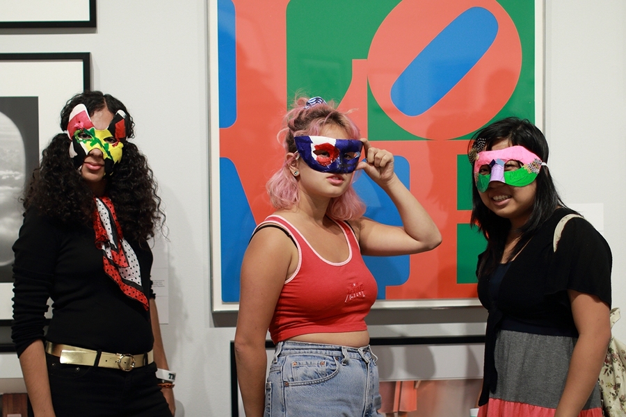 MIT students pose with masks inspired by the List Visual Arts Center's annual Student Loan Art Program exhibition. Each year, students have the opportunity to enter a lottery to borrow a work of art from the List's collection for their living spaces during the academic year. 