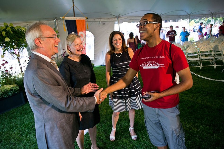 (From left) President Reif, Christine Reif, and Chancellor Cynthia Barnhart meet a student. 
