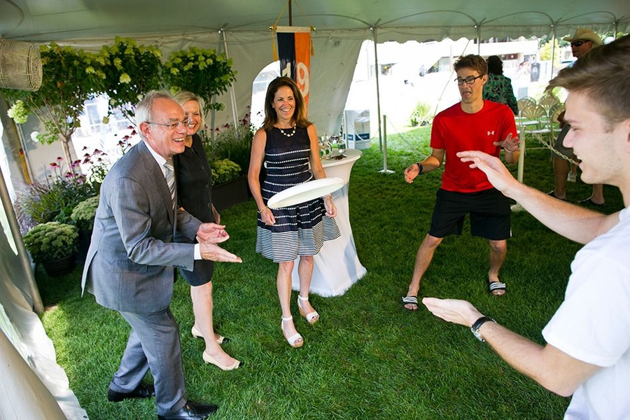 (From left) President Reif, Christine Reif, and Chancellor Cynthia Barnhart play frisbee with students.