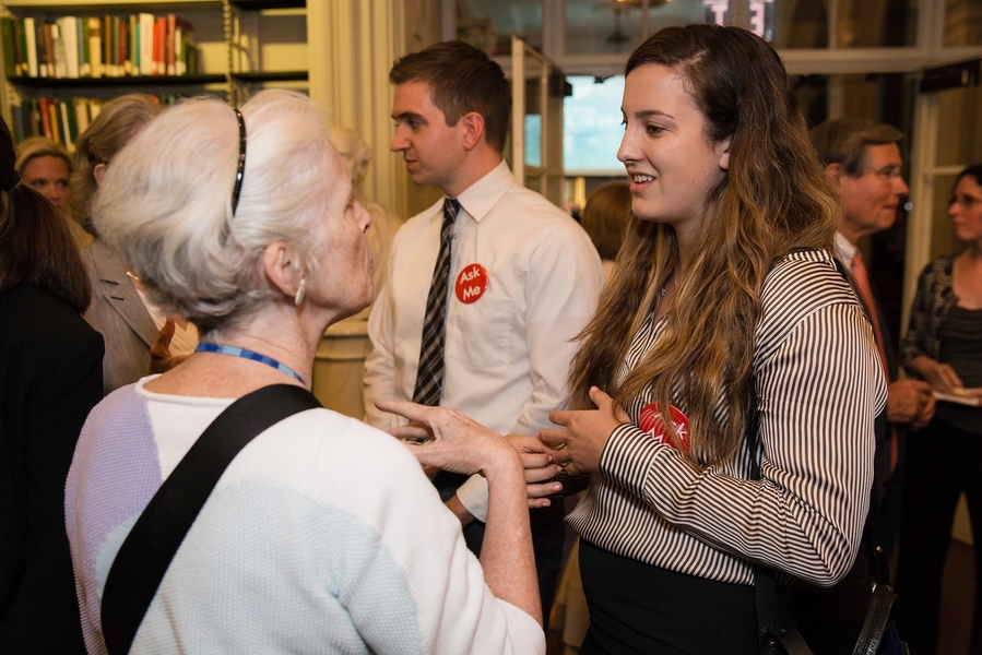 Madison Noteware, an MIT senior in civil and environmental engineering, converses with attendees during the event reception.