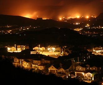 The Next-Generation Incident Command System (NICS) was initially applied to wildfire suppression efforts in California to prevent forest fires like this one from spreading to densely populated communities.