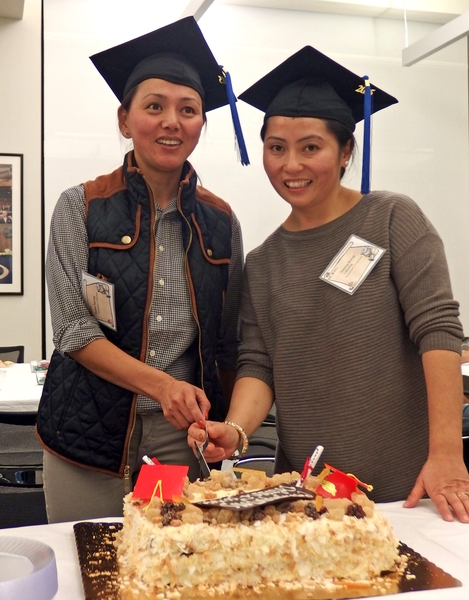Dolma Tsering (left) and Tsering Mulug-Labrang celebrate after earning their high school diplomas thanks to MIT’s ESL Program for Service Employees.