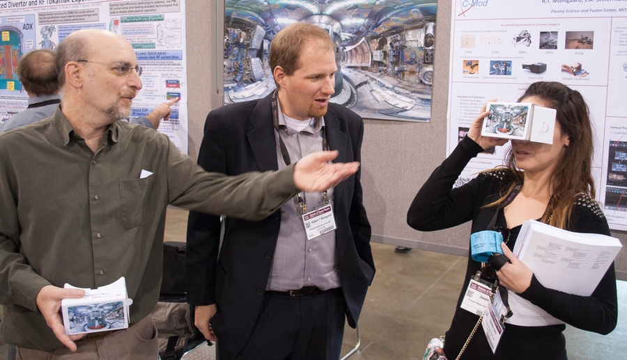 Josh Stillerman (left) and Bob Mumgaard help guide conference attendee Deedee Ortiz through virtual rooms of a 3-D tokamak fusion device.