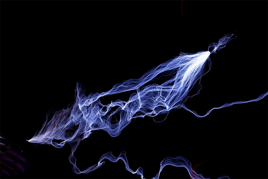 Sparks of electricity illuminate the air between two tesla coils at the Museum of Science in Boston.