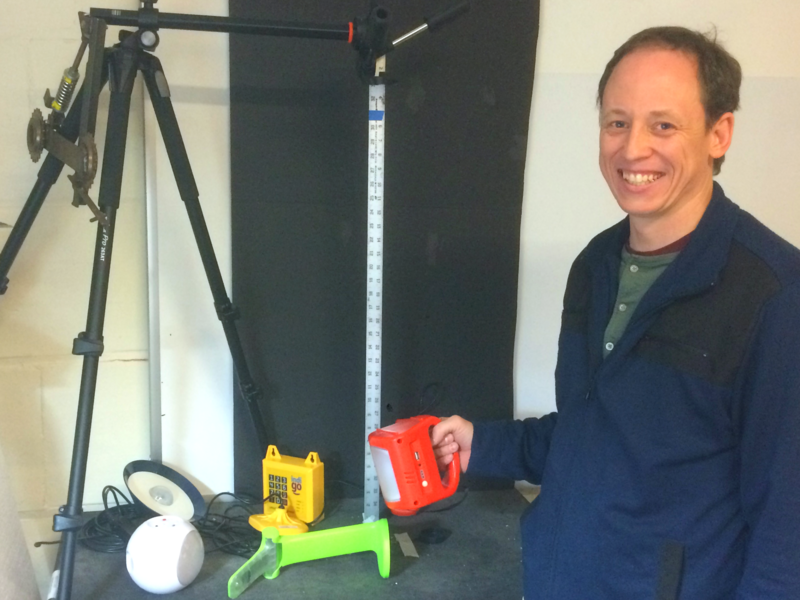 Eric Verploegen PhD '08, who leads the D-Lab Off-Grid Energy Group, is pictured with a range of solar lighting products included in the Solar Lantern Product Comparison database he launched recently.