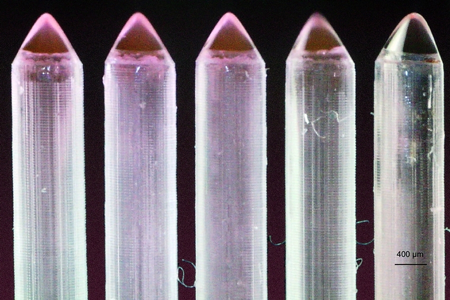 External row of seven emitters that are part of a 49-emitter array. The scalloping on the exterior of the emitters, due to the layer-by-layer manufacturing, is visible.