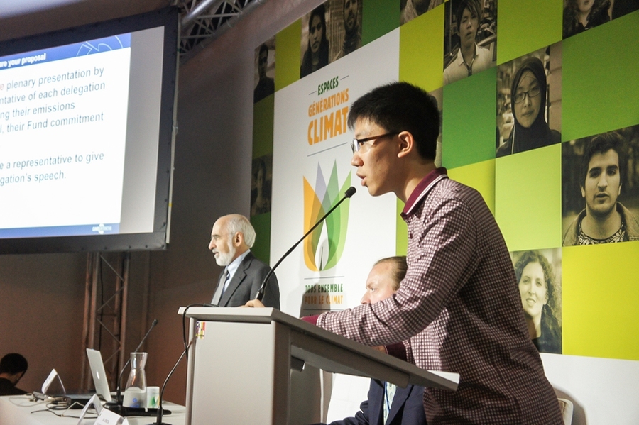 Chinese high school student Raymond Song represents the U.S. in the World Climate role-play, addressing delegates as President Barack Obama.