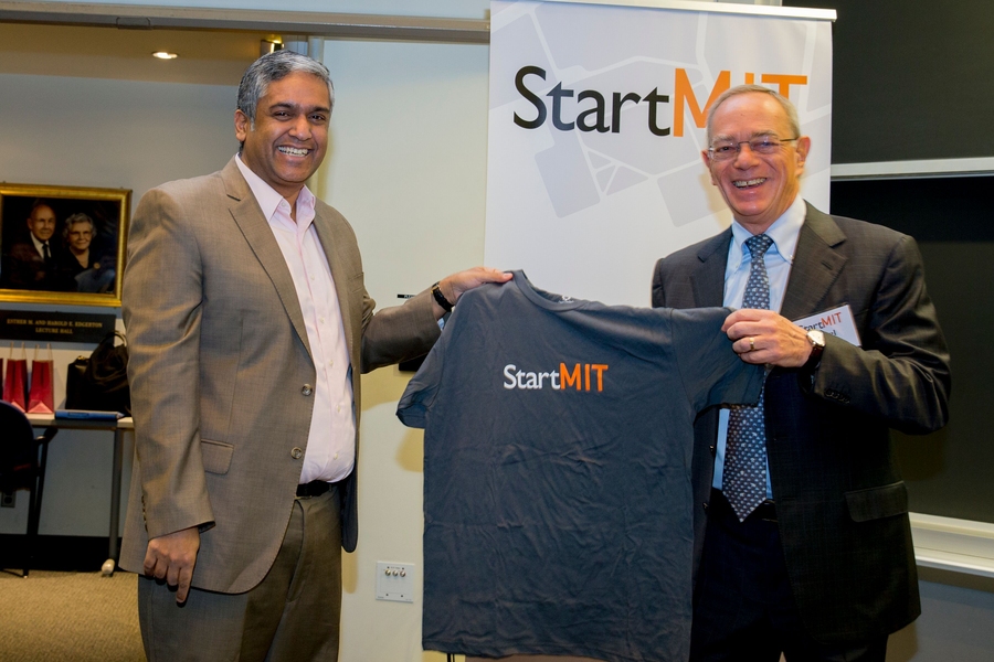 StartMIT head organizer and EECS department head Anantha Chandrakasan (left) presents President L. Rafael Reif with a course shirt.