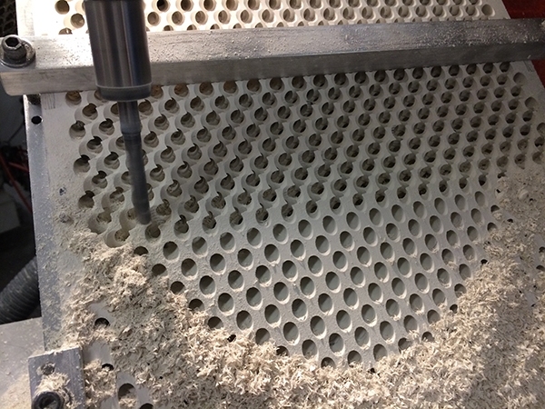 A gyroid slab undergoes a drilling process.