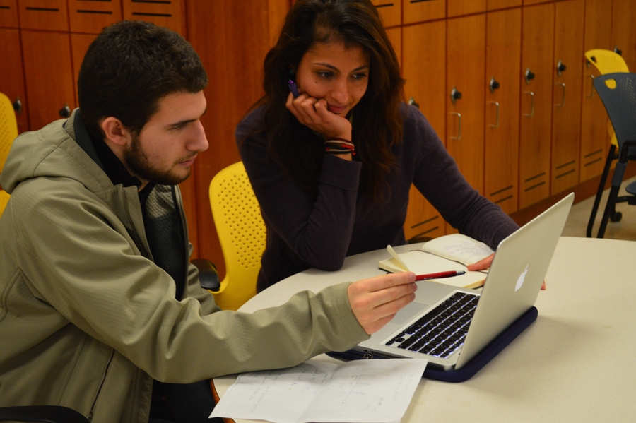 Postdoc Sarah Safieddine (right) of Professor Colette Heald's lab mentors freshman Ethan McGarrigle on air quality.