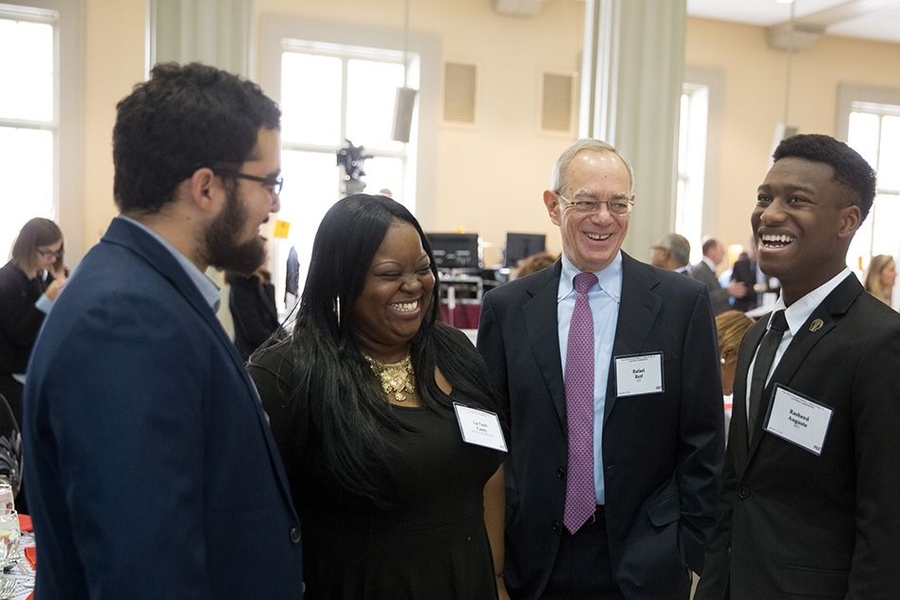 (Left to right) Alberto Hernandez, La-Tarri Canty, President Rafael Reif, and Rasheed Auguste have a conversation before the luncheon.
