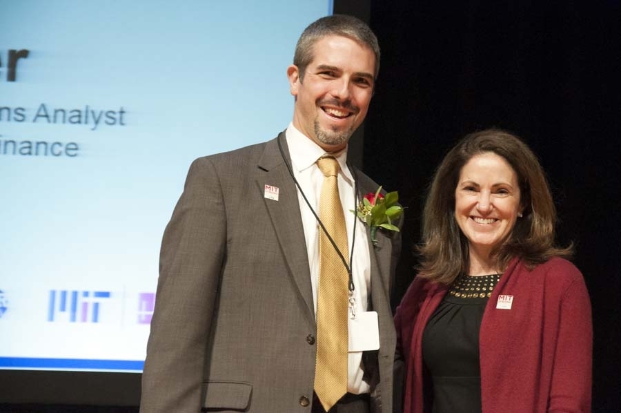 Gilles Simler, senior business intelligence solutions analyst in the Office of the Vice President for Finance, receives an Innovative Solutions award from Chancellor Cynthia Barnhart.