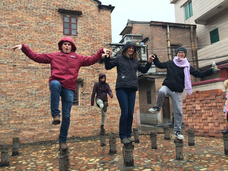 Students pose for a photo while visiting an ancient village in southern China.