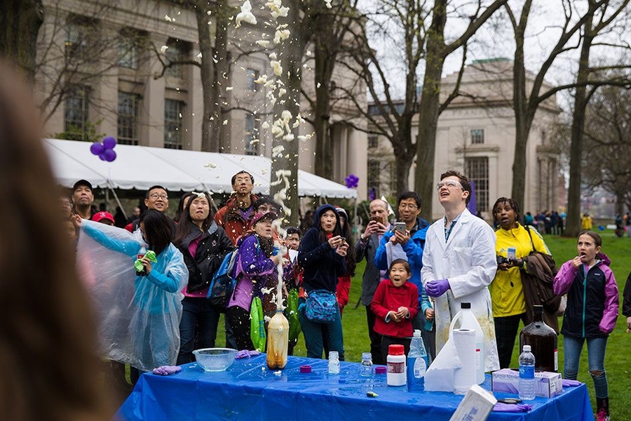People gather to watch a demonstration on Killian Court.