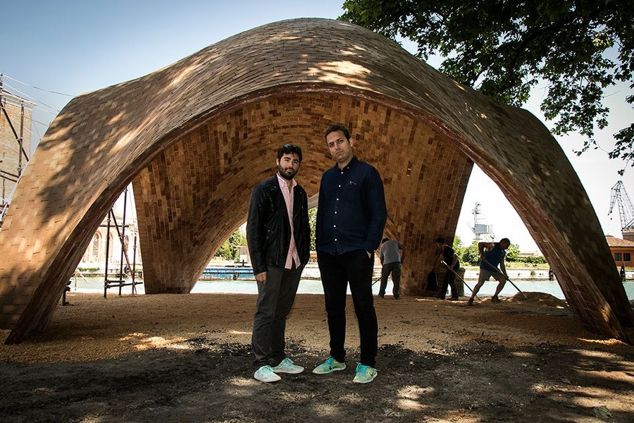 This earthen masonry shell made from thin tiles is a full-scale prototype “droneport” for use by fleets of cargo drones that will deliver goods to rural areas of Rwanda that lack roads. MIT graduate students Luisel Zayas (left) and Sixto Cordero spent the past four months in Spain preparing for the construction of the vault.