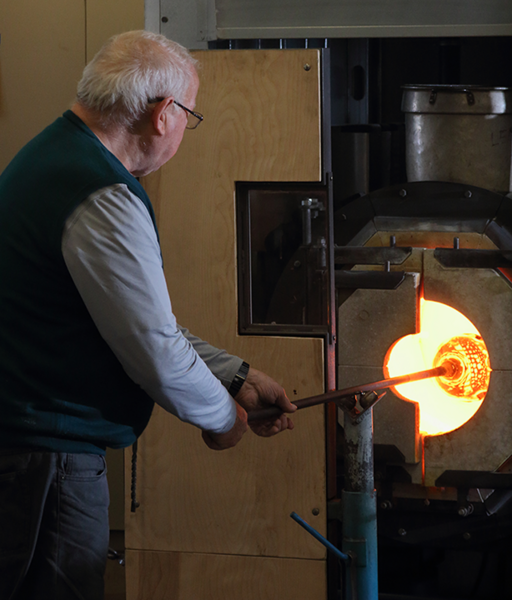 Glory hole: Lino Tagliapietra heats and turns a glass piece in a glory hole at MIT Glass Lab.
