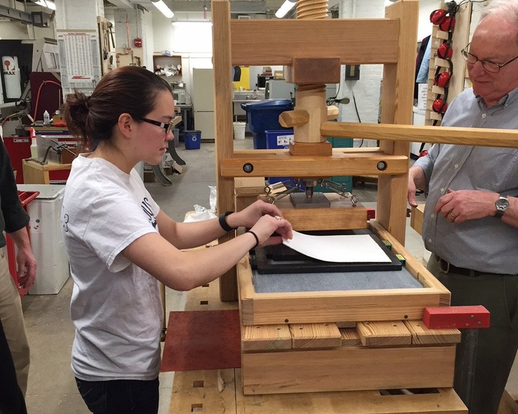 “MIT students have an interest in preserving good forms of older technology and not just moving forward without looking back at what was good about the past. And being able to engage with history in the same way is really powerful,” says Tasha Schoenstein '16, mathematics and computer science major. Pictured: Kathryn Hendrickson operates the completed handset press.