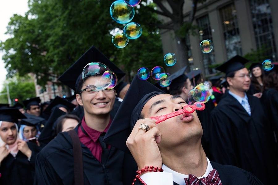 Student blows bubbles at MIT Commencement