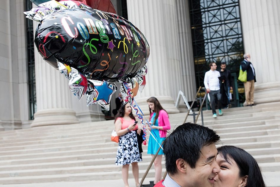 Couple kisses on the steps of Massachusetts Ave. on MIT Comencement Day