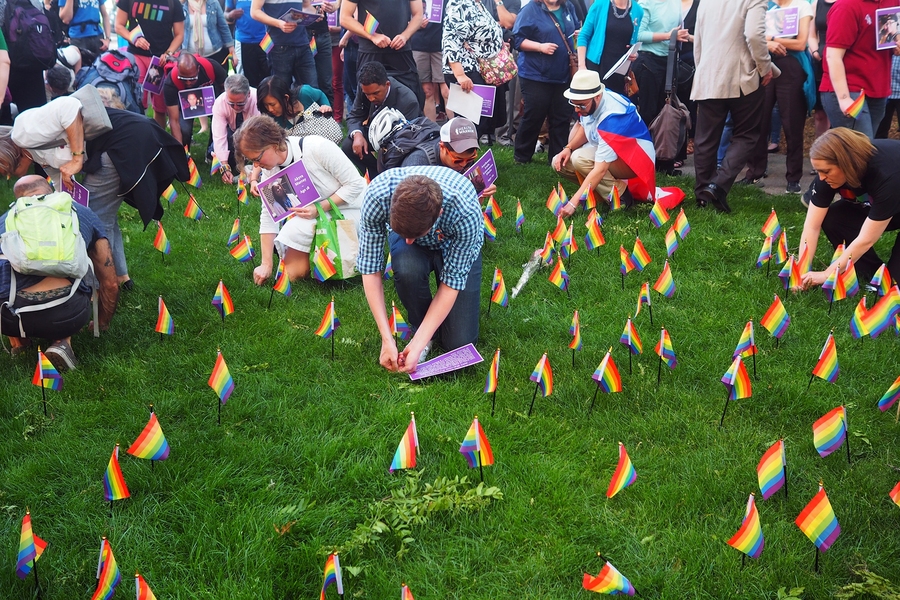 Community members planted pride flags to commemorate those killed at the Pulse night club in Orlando, Florida. Additional photos of the vigil and procession can be seen in the slideshow below.