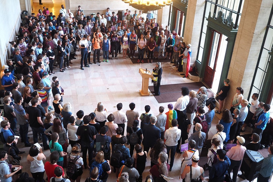 Muslim Chaplain Hoda Elsharkawi addresses community members gathered for reflection in Lobby 7.
