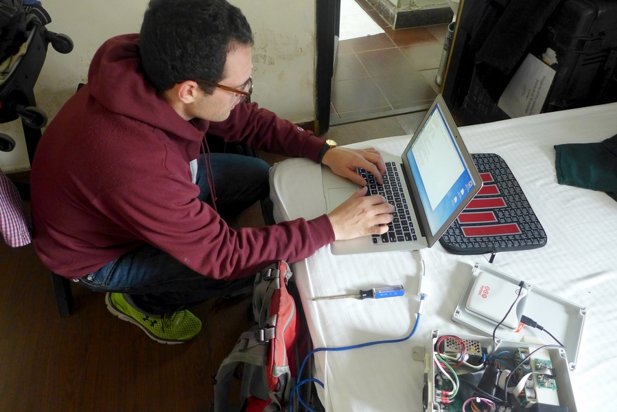 David Hagan, a Tata Fellow and PhD candidate in civil and environmental engineering, is designing and building low-cost sensors that could be deployed in dense networks to monitor air pollution. Here, Hagan makes some last-minute tweaks to his prototype in a hotel room in New Delhi, India.