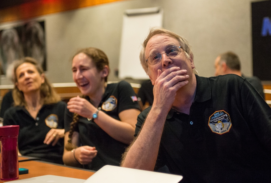 MIT Professor Richard Binzel (right), a scientist on NASA's New Horizons mission, reacts to seeing the spacecraft's sharpest image of Pluto before closest approach on July 14, 2015, at the Johns Hopkins University Applied Physics Laboratory in Laurel, Maryland. With him are MIT graduate student Alissa Earle (center), and Cristina Dalle Ore, senior scientist at the SETI Institute.