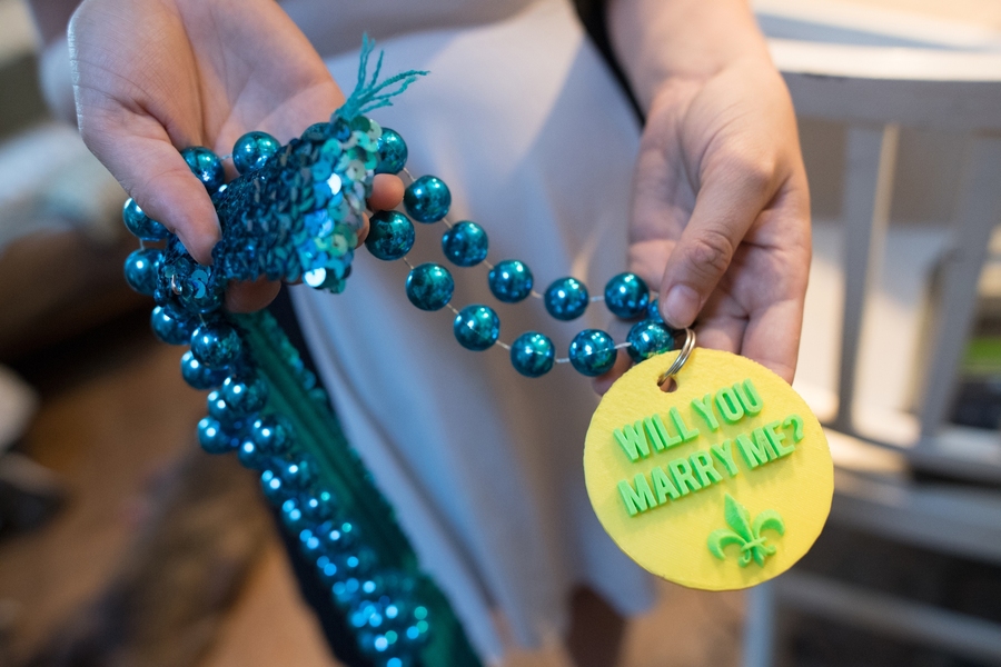 Casey Forster holds the playfully gaudy necklace that her husband, Bobby, gave her when he dropped to one knee and proposed at a Mardi Gras celebration in New Orleans less than two years ago.