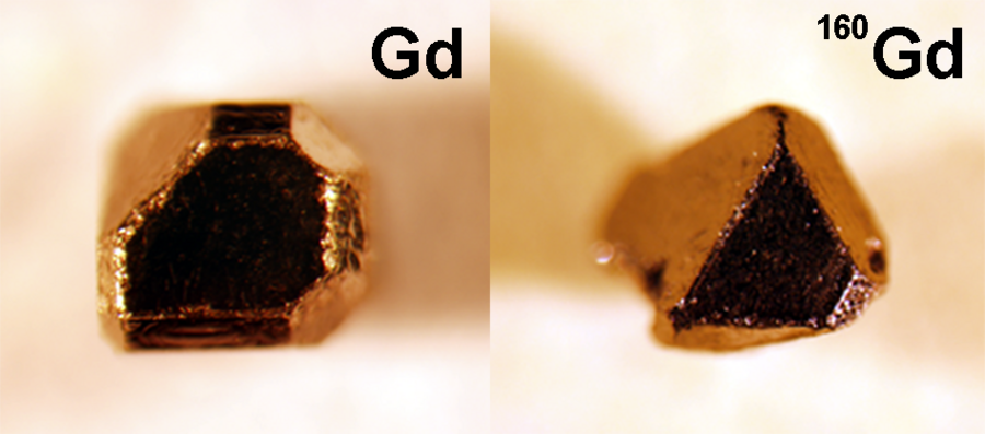 At left: A single crystal compound of gadolinium, platinum, and bismuth made with naturally occurring elements. At right, a single crystal of this material made with isotopically enriched gadolinium for neutron scattering experiments. Both crystals are approximately 1 mm in size.