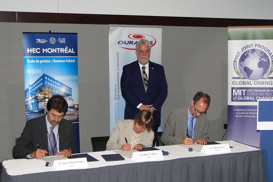 Québec Premier Philippe Couillard looks on as Professor Pierre-Olivier Pineau, chair in energy sector management at HEC Montréal; MIT Vice President for Research Maria Zuber; and Ouranos Executive Director Alain Bourque sign the cross-border research collaboration agreement.