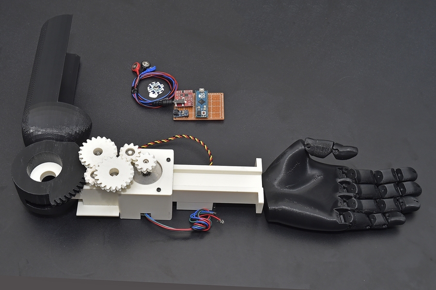 The mechanical arm pictured here was created for people without a wrist or arm. The herringbone gears and arm base are printed in one full piece. Once that piece is printed, an Arduino motherboard and sensors, pictured above the arm, and a motor are attached to the arm.