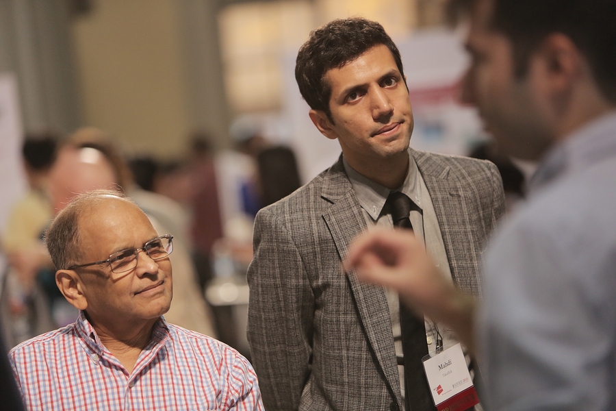 MechE alumnus Ani Chitaley '68 (left) and postdoc Mahdi Takaffoli listen to a presentation.