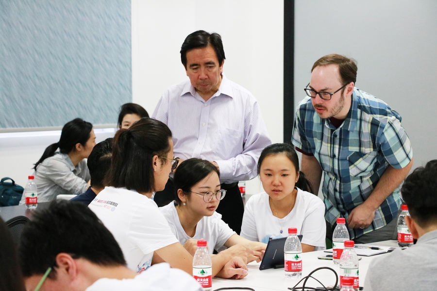 Students in Xiamen, China play the game with guidance from Yu-Hung Hong, director of the STL Lab, and Richard Eberhardt of the MIT Game Lab. 