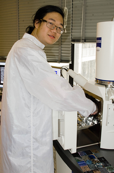  Summer Scholar Justin Cheng inserts a sample into a scanning electron microscope in MIT's NanoStructures Laboratory. Cheng explored processes for making ordered metal nanostructures that display interesting new properties. 