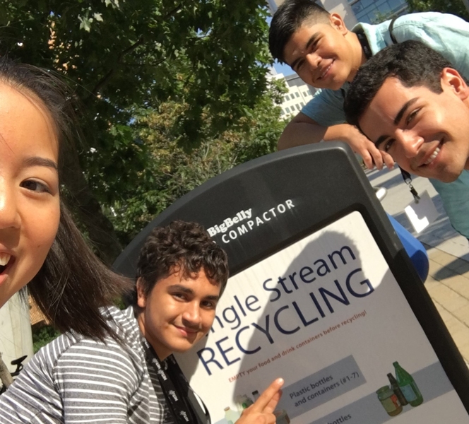 On the Energy Scavenger Hunt around the MIT campus, Michelle Bai, Jose Domingo Soto Rivera, Alejandro Gonzalez, and Dylan Lewis check off their task of finding something energy-related as they take a selfie with one of the BigBelly solar-powered trash compactors.