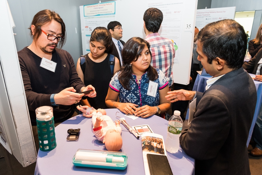 An exhibition of Tata Center projects gave attendees the chance to talk with MIT graduate students like Xavier Soriano (left) and Honey Bajaj (second from right), who are developing a kit of tools to aid community health workers in India.