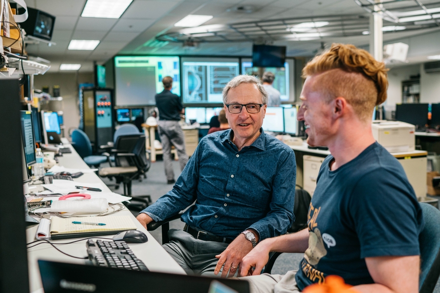 Alex Tingly (right), a graduate student in the Department of Physics, and senior research scientist Earl Marmar, head of the Alcator C-Mod project since 2002, review data on synchrotron emission from relativistic electrons in plasma.