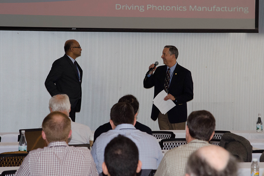 Sanjay Pai of Intel Corp. (standing left) answers a question during a session on integrated photonics manufacturing. Pai, Intel’s Supply Chain integration manager, delivered the keynote talk on “Building a Silicon Photonics Supply Chain.” Session chair Thomas Koch, dean of the College of Optical Sciences at the University of Arizona, is at right.