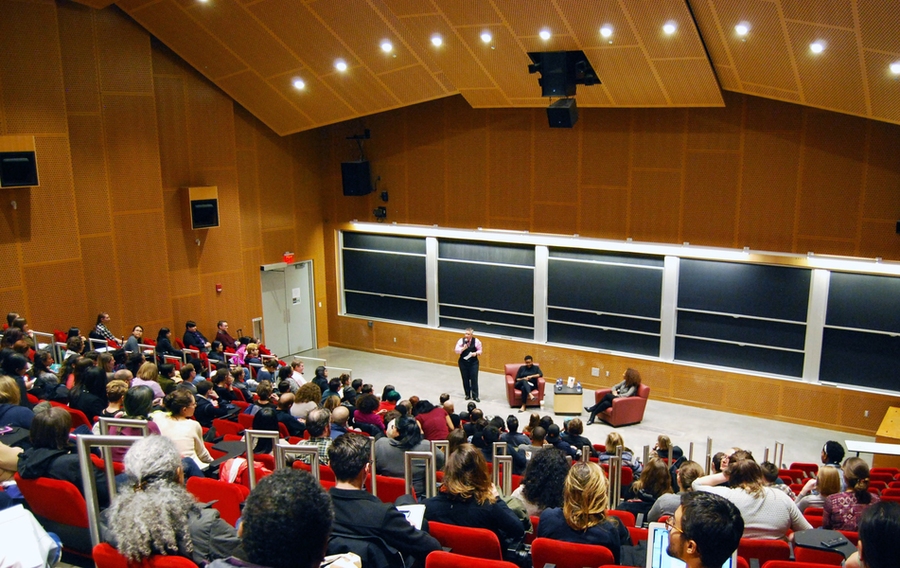 MIT Libraries Director Chris Bourg (standing) introduces Janet Mock (seated, right) and Syn Odu. 