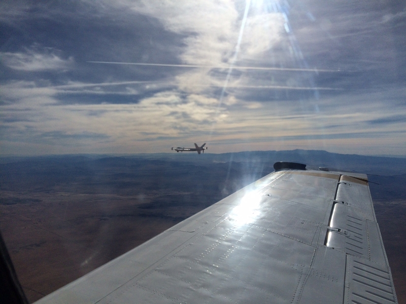 NASA's Ikhana unpiloted aircraft system (in background) flies with ACAS Xu avionics during a 2014 flight test.