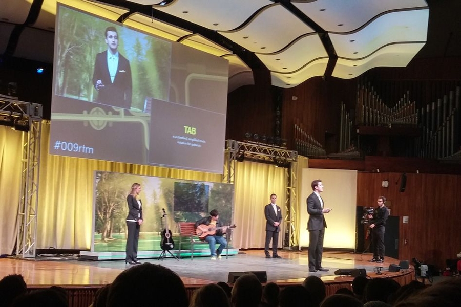 “Team Yellow” demonstrates their product design, called Strum, which offers a way for guitar players to automatically record the notes they play, without having to remember the notes and put down the instrument to record them.