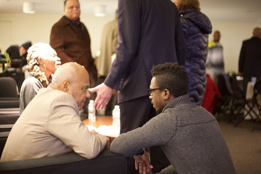 Robert Moses, left, who co-founded the Algebra Project with his wife, Janet Moses, speaks with an audience member after the luncheon.