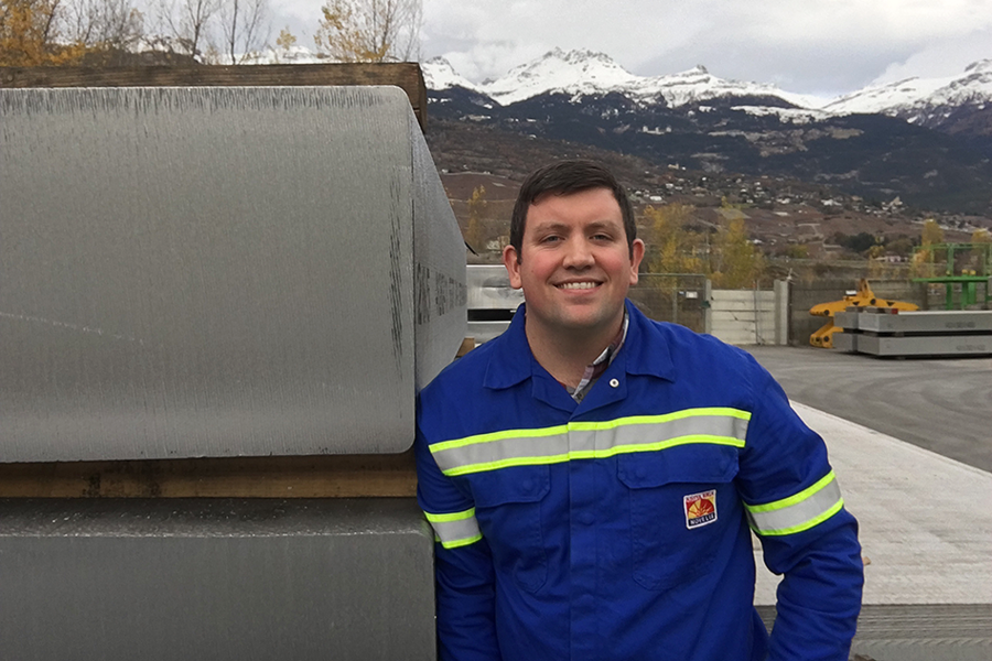 Samuel Wagstaff PhD ’16 stands next to 6,000 aluminum alloy ingots at Novelis in Sierre, Switzerland. Over the past three years, Wagstaff and MIT assistant professor of metallurgy Antoine Allanore developed a new process that uses a turbulent jet to reduce macrosegregation defects in aluminum alloys by 20 percent. The ingots pictured are destined for the Land Rover-Jaguar group.