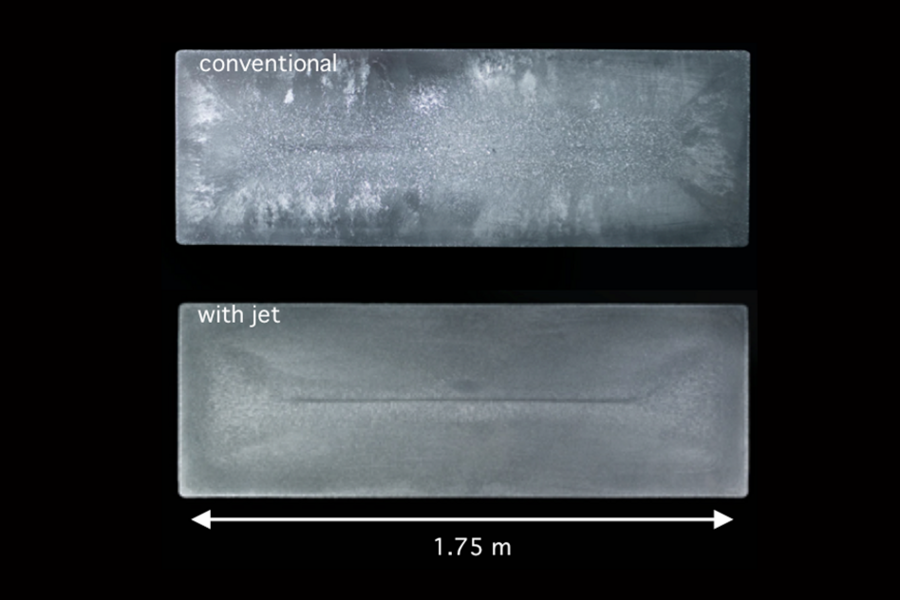 Solidified cross-sections from aluminum ingots were made using a conventional method (top) and a new jet metal process developed by MIT researchers. “The introduction of the jet induced a completely different recirculation of the grains, and therefore you get different microstructure all along the section,” says MIT Assistant Professor Antoine Allanore.